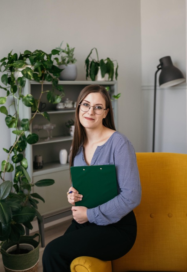 Psychiatrist holding a clipboard in a consultation room